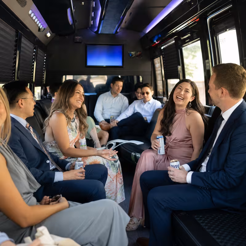 Wedding guests seated inside a Milwaukee party bus