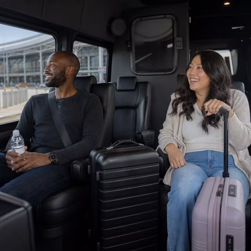 Passengers loading luggage while boarding an Milwaukee group shuttle