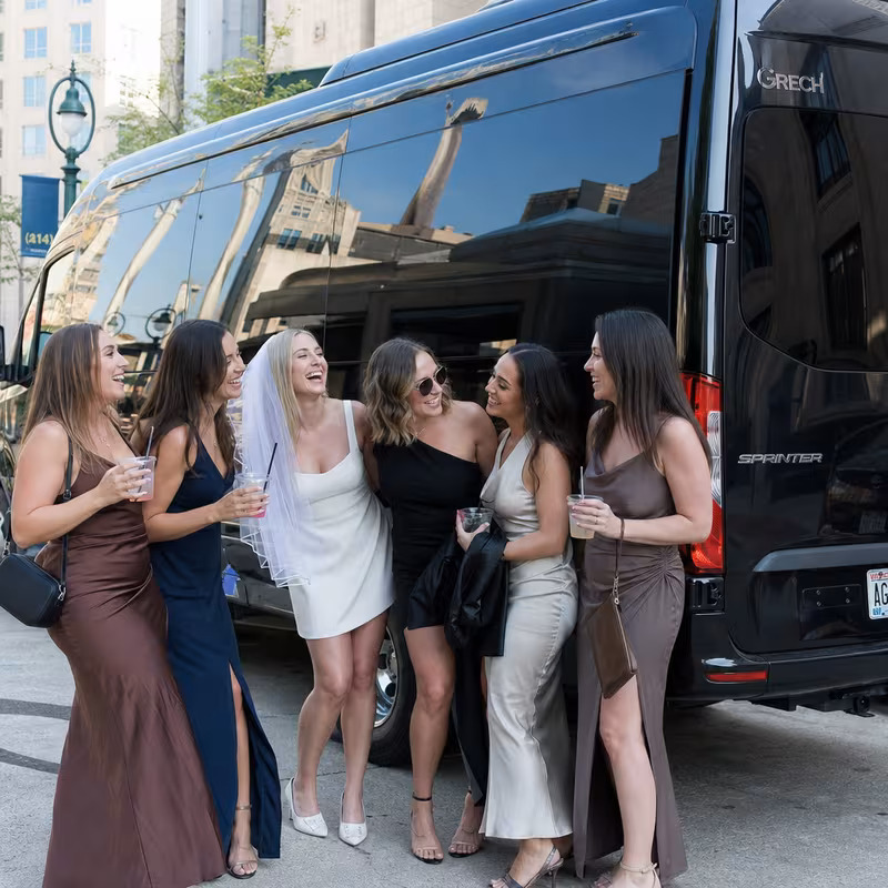 Group boarding a white charter bus for Bachelor & Bachelorette Transportation transportation in Milwaukee
