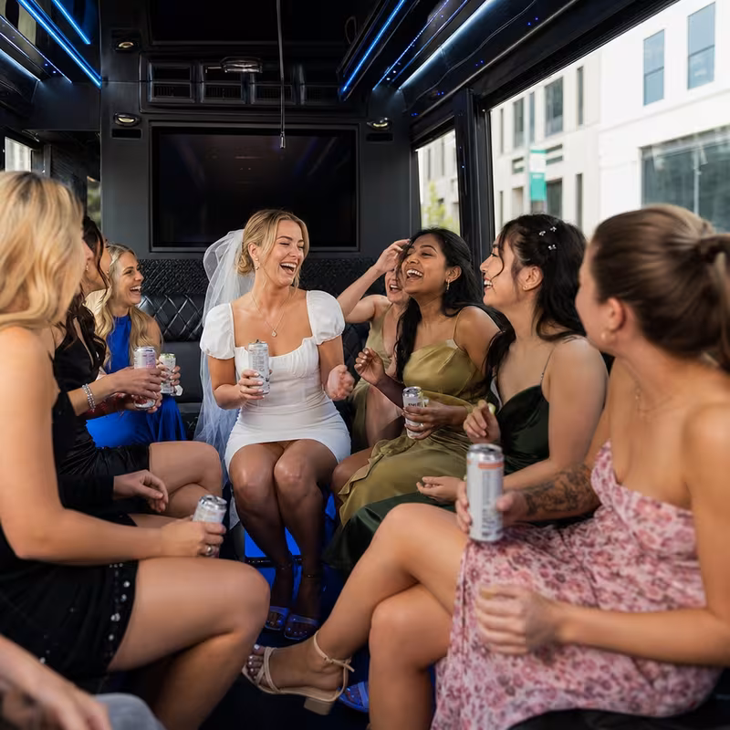 Party bus interior with wraparound leather seating and LED lighting in Milwaukee