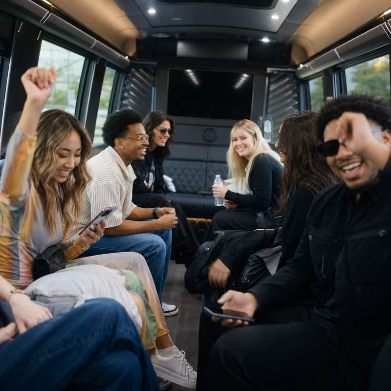 Group boarding a white charter bus for Concert Transportation transportation in Milwaukee