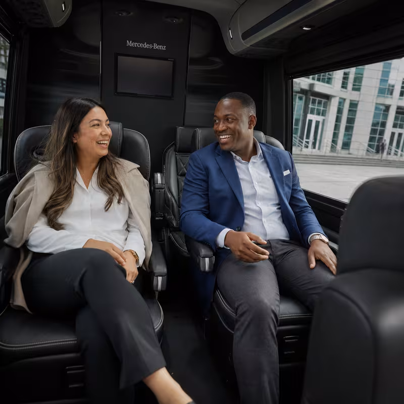 Group boarding a white charter bus for Corporate Transportation transportation in Milwaukee