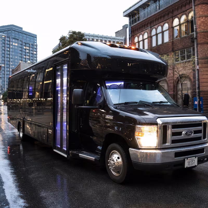 Party bus interior with wraparound leather seating and LED lighting in Milwaukee