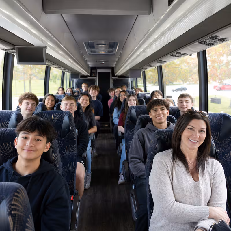 Group boarding a white charter bus for School Transportation transportation in Milwaukee