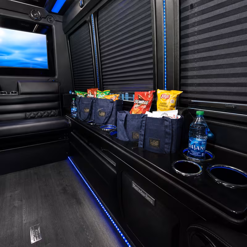 Party bus interior with wraparound leather seating and LED lighting in Milwaukee